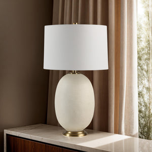 Cartagena Table Lamp placed on a marble surface with a backdrop of curtains and natural light