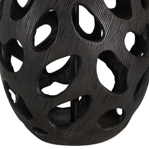 Close-up of Loxley Table Lamp's black base featuring cut-out patterns and textured surface.
