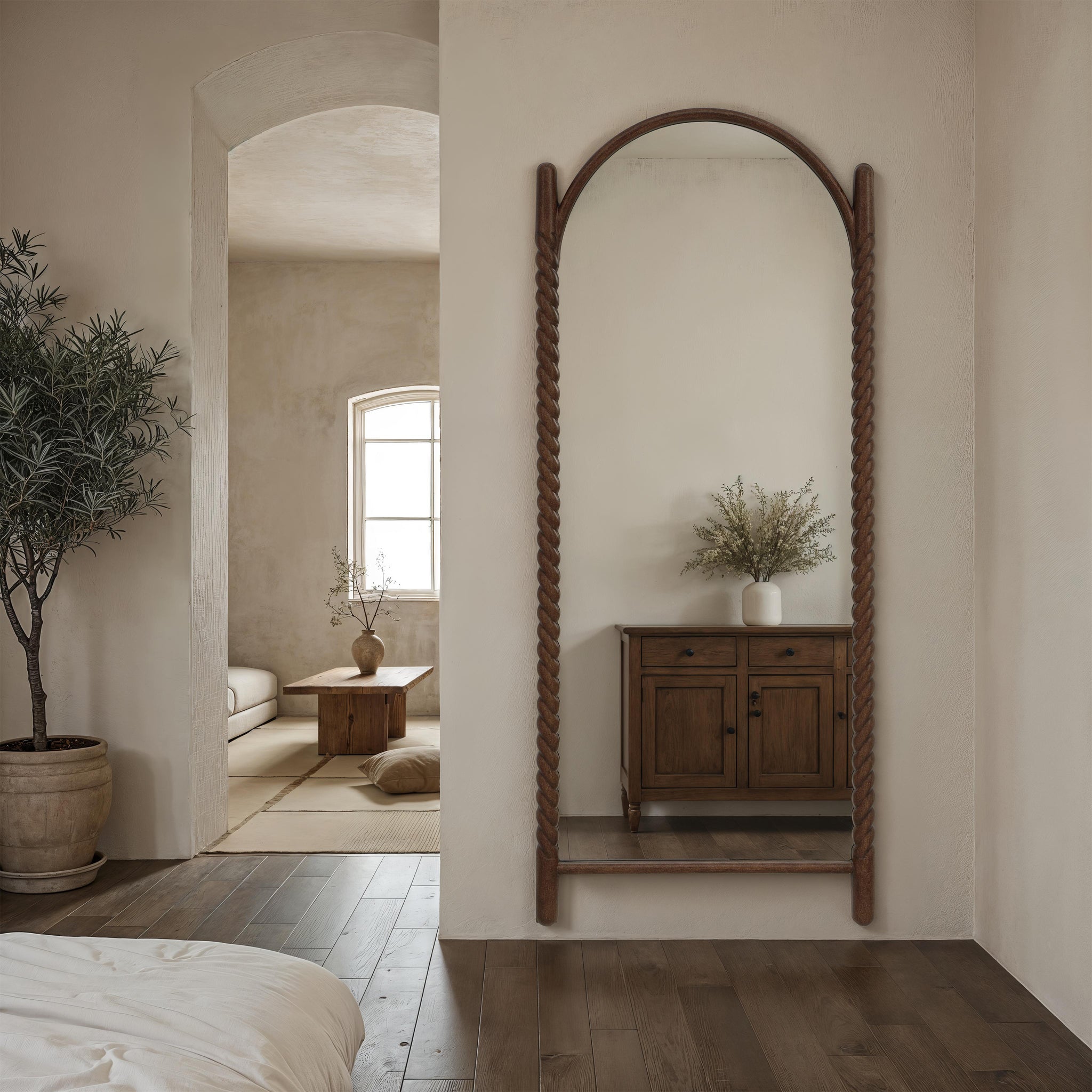 Ignatius mirror in a styled interior, reflecting a cozy room with wooden furniture.