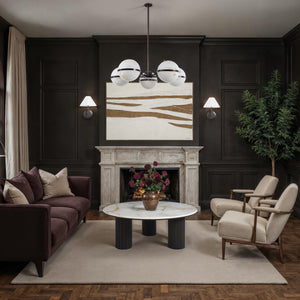 Muralis canvas art featuring abstract gold and white design above a modern living room fireplace