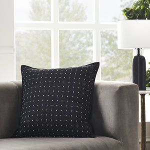 Brittany Indoor Pillow in black with white square pattern, placed on a gray sofa.