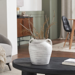 Blanco vase by Renwil on a black table, filled with dried branches in a modern living room