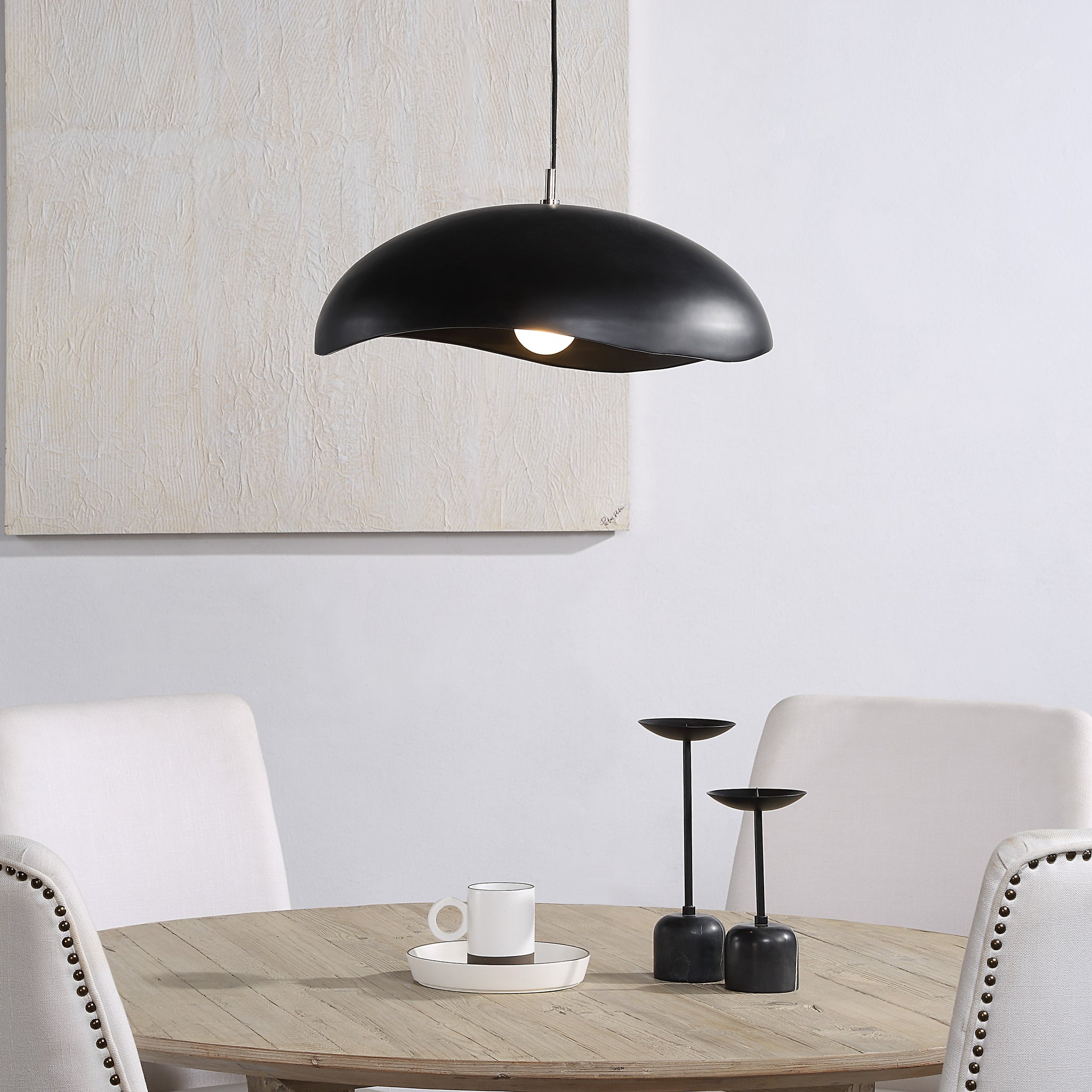 Filomena Ceiling Fixture above a dining table, illuminating a cozy setting with decor.