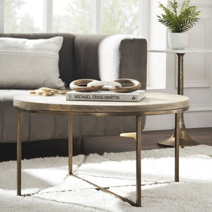 Liana Table styled in a living room setting with a book and decorative rings on top.