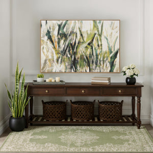 Minthe canvas art displayed above a wooden console table with decorative items and plants