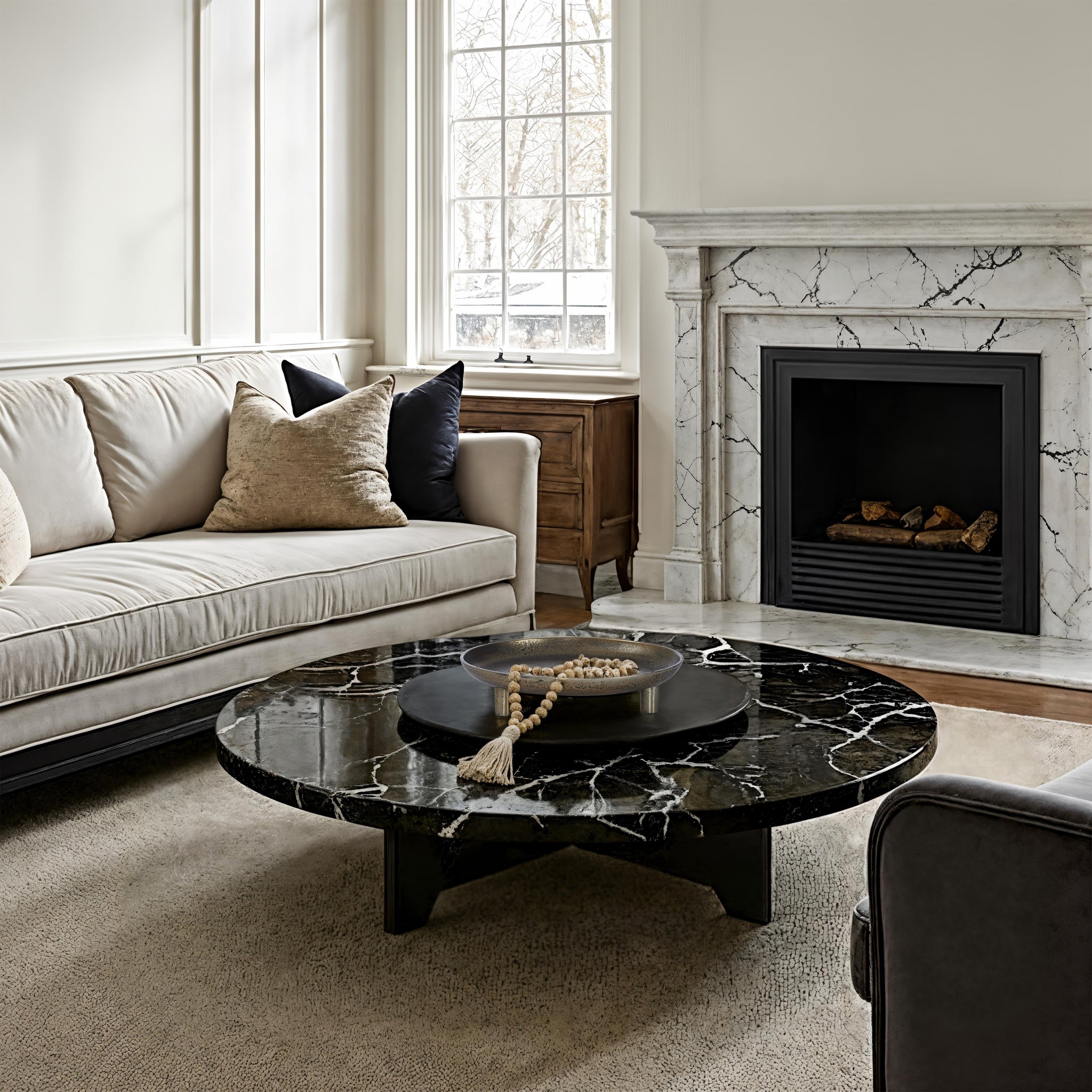 Kaleido Indoor Cast Aluminum Tray displayed on a black marble coffee table in a cozy living room