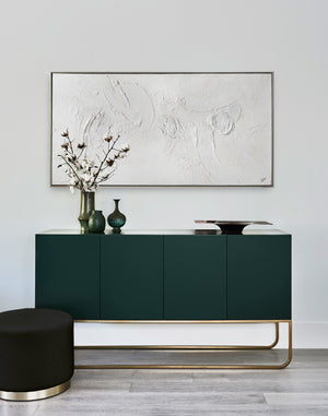 Yanno canvas art displayed above a modern green cabinet with decorative vases and flowers.