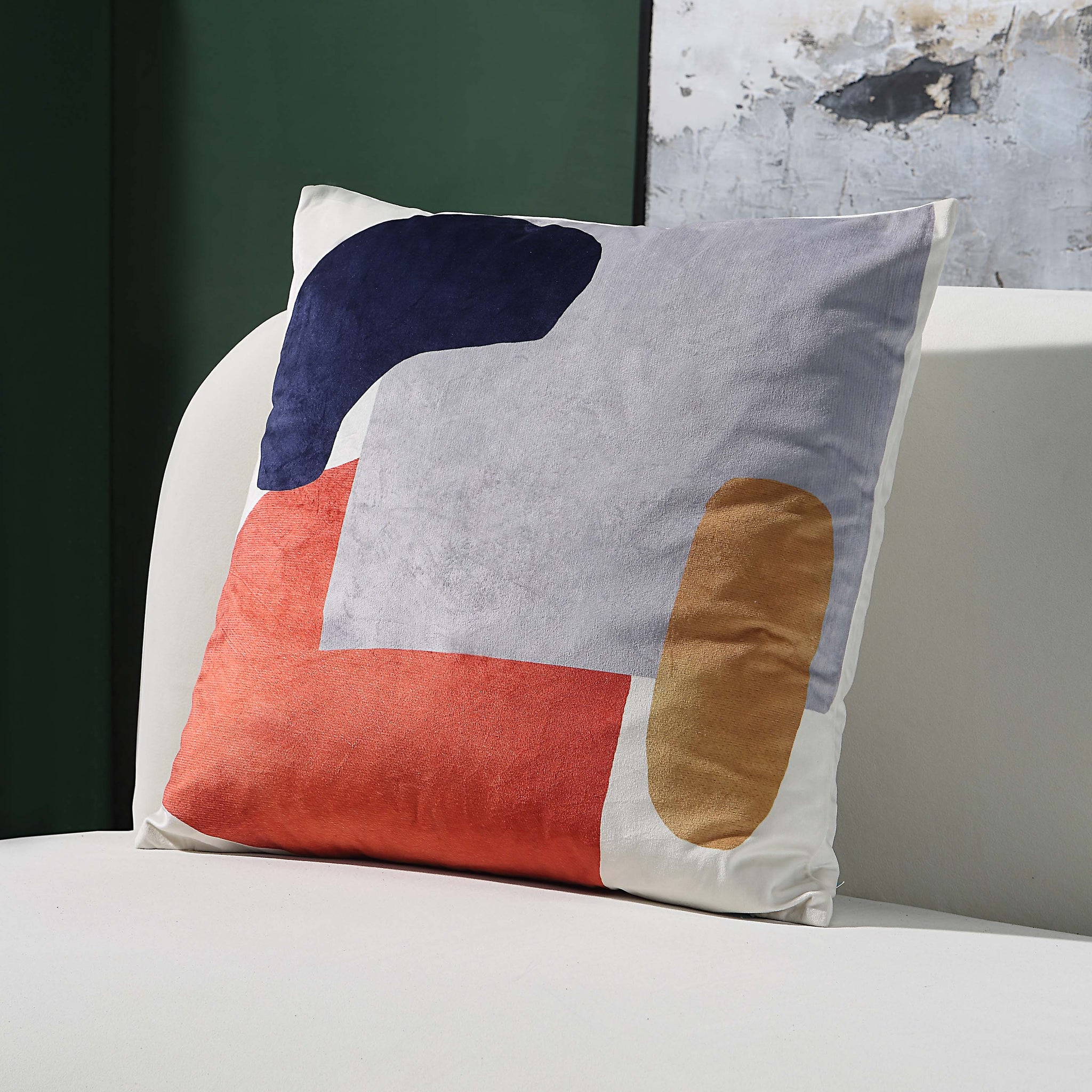 Lonzo Indoor Pillow featuring a colorful abstract pattern, displayed on a sofa.