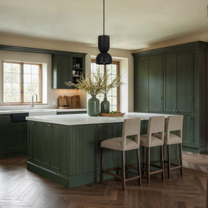 Caen chandelier in a stylish kitchen setting above a green island.