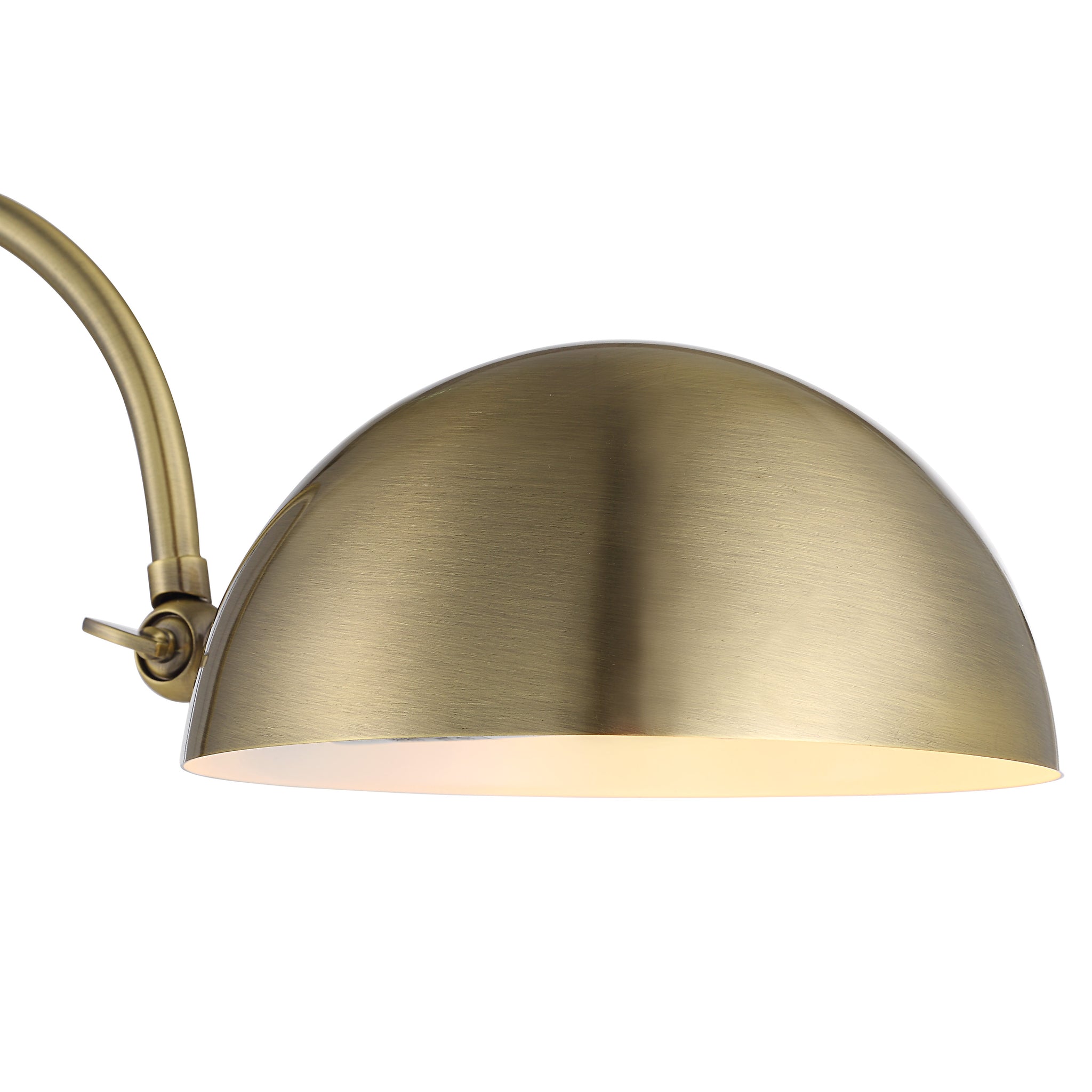 Close-up of the Volos Table Lamp's dome brass shade, highlighting its smooth finish and design.