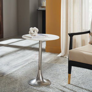 Eloa table with a white marble top, books, and a decorative knot on top