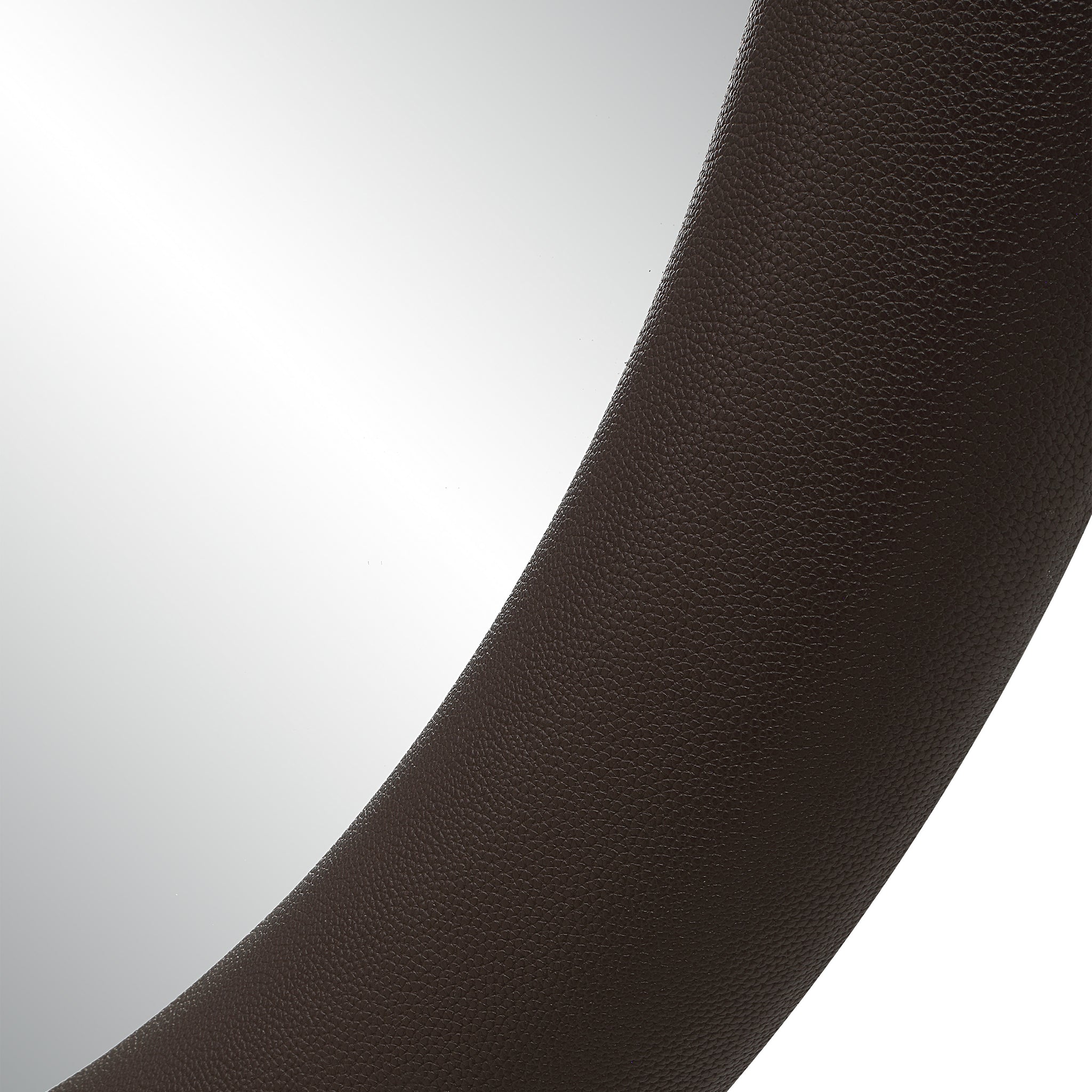 Close-up of Potro mirror showing the textured brown leather frame.