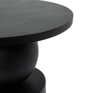 Paola Side Table featuring a round black top and a sculptural base.