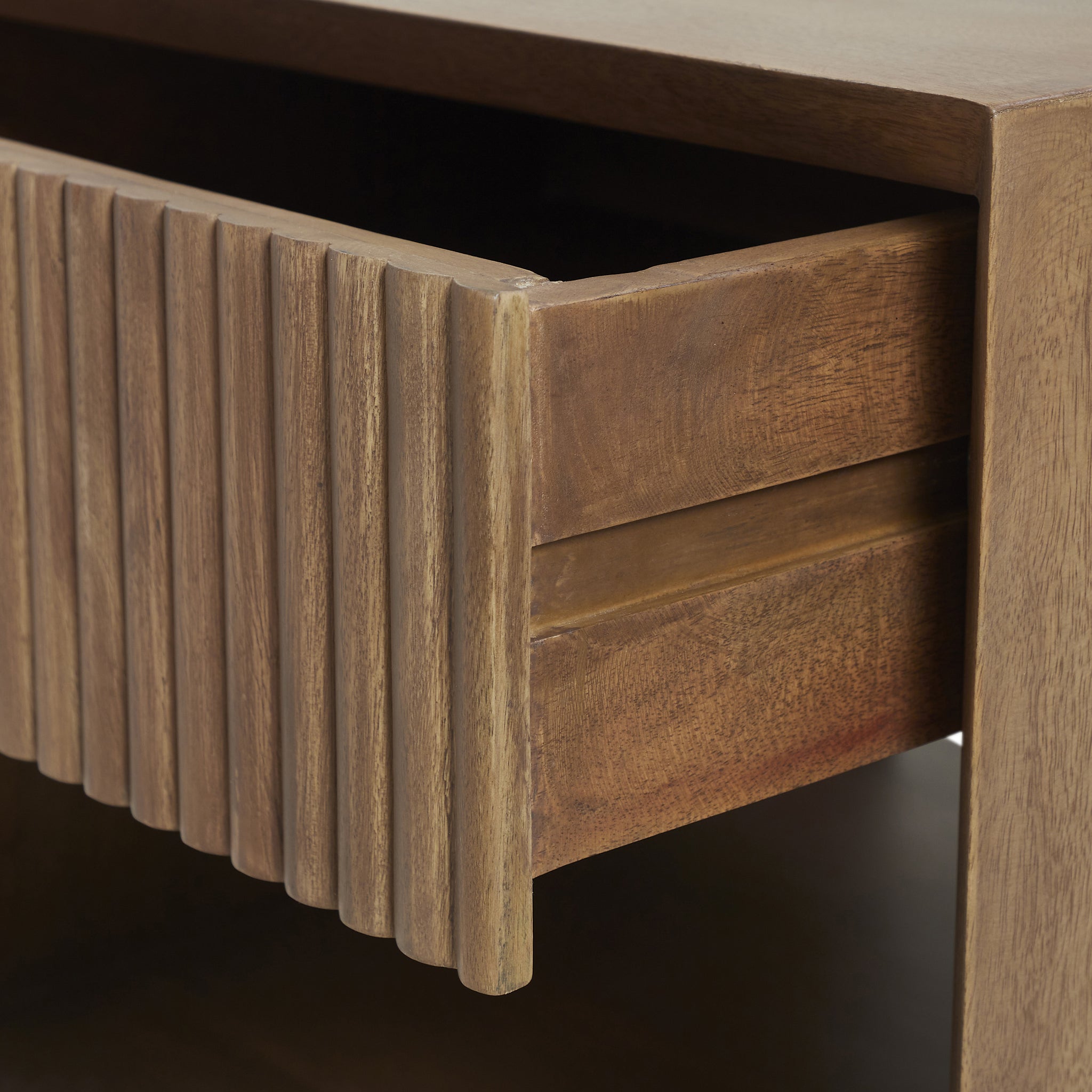 Close-up of the Jaime side table's textured drawer front, emphasizing the wood detail.