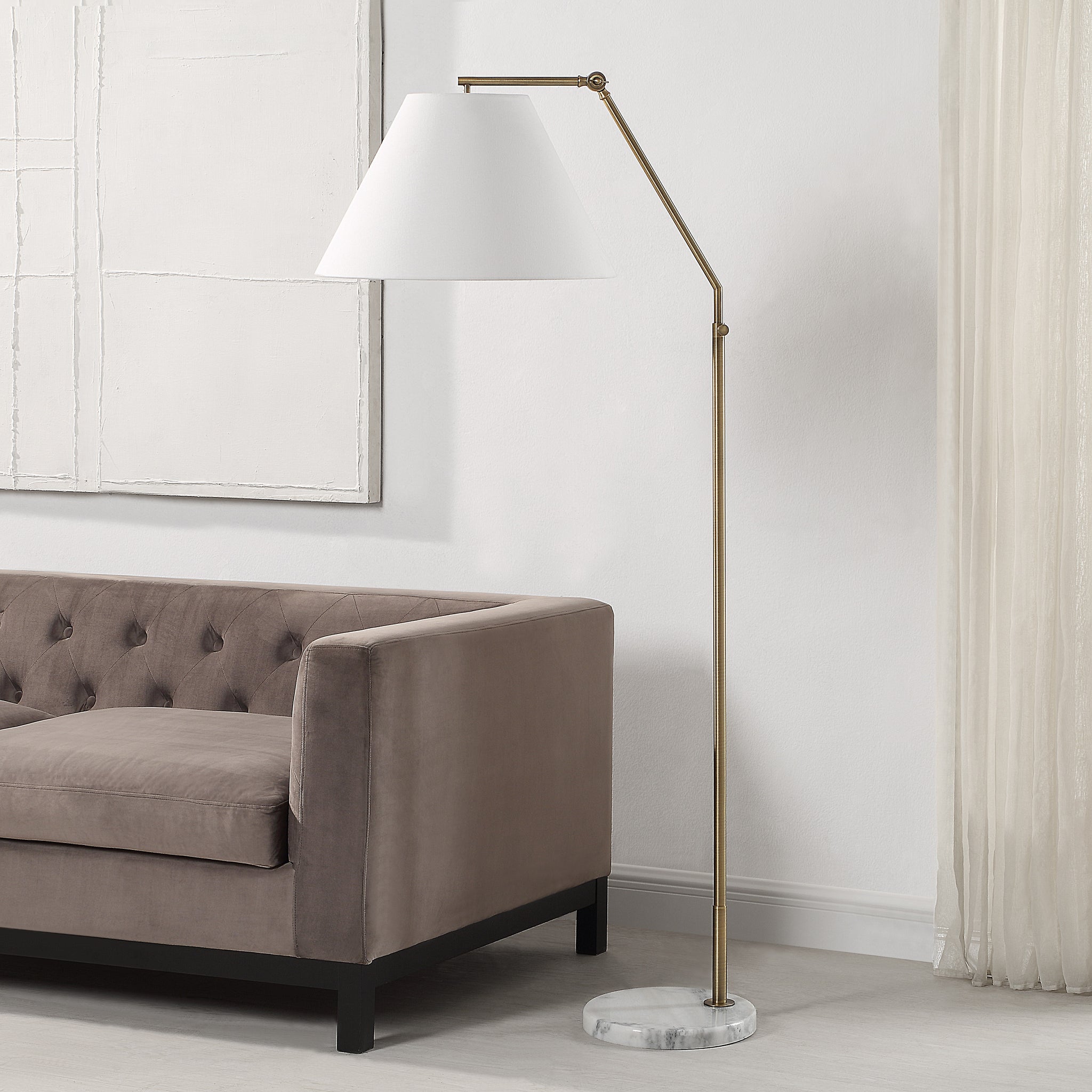 Claire Floor Lamp beside a gray velvet sofa in a modern living room