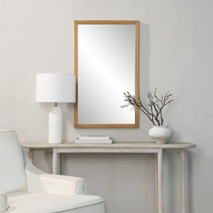 Salia mirror by Renwil displayed in a room setting, paired with a lamp and decorative vase.