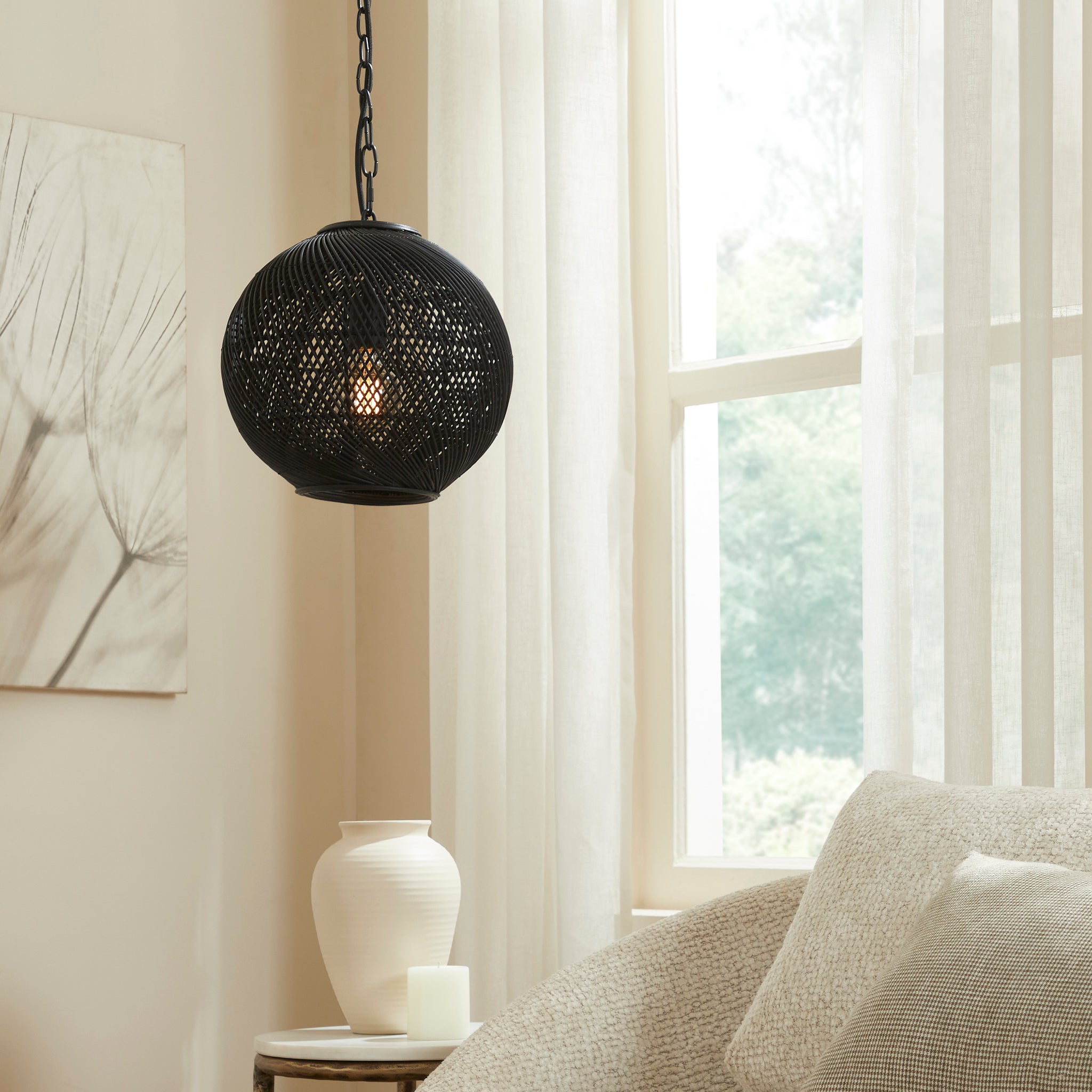 Romika black ceiling light fixture hanging in a bright room with curtains.