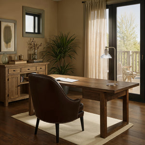 Samos table lamp on a wooden desk in a cozy office setting with plants.