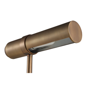 Gusle table lamp in brushed bronze finish with a cylindrical shade and sleek design, viewed from an angle.