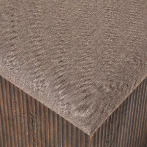 Close-up of Tristan stool's herringbone fabric top and dark wood base.