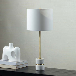 Talulla Table Lamp styled on a black table next to a white sculpture and stacked books.