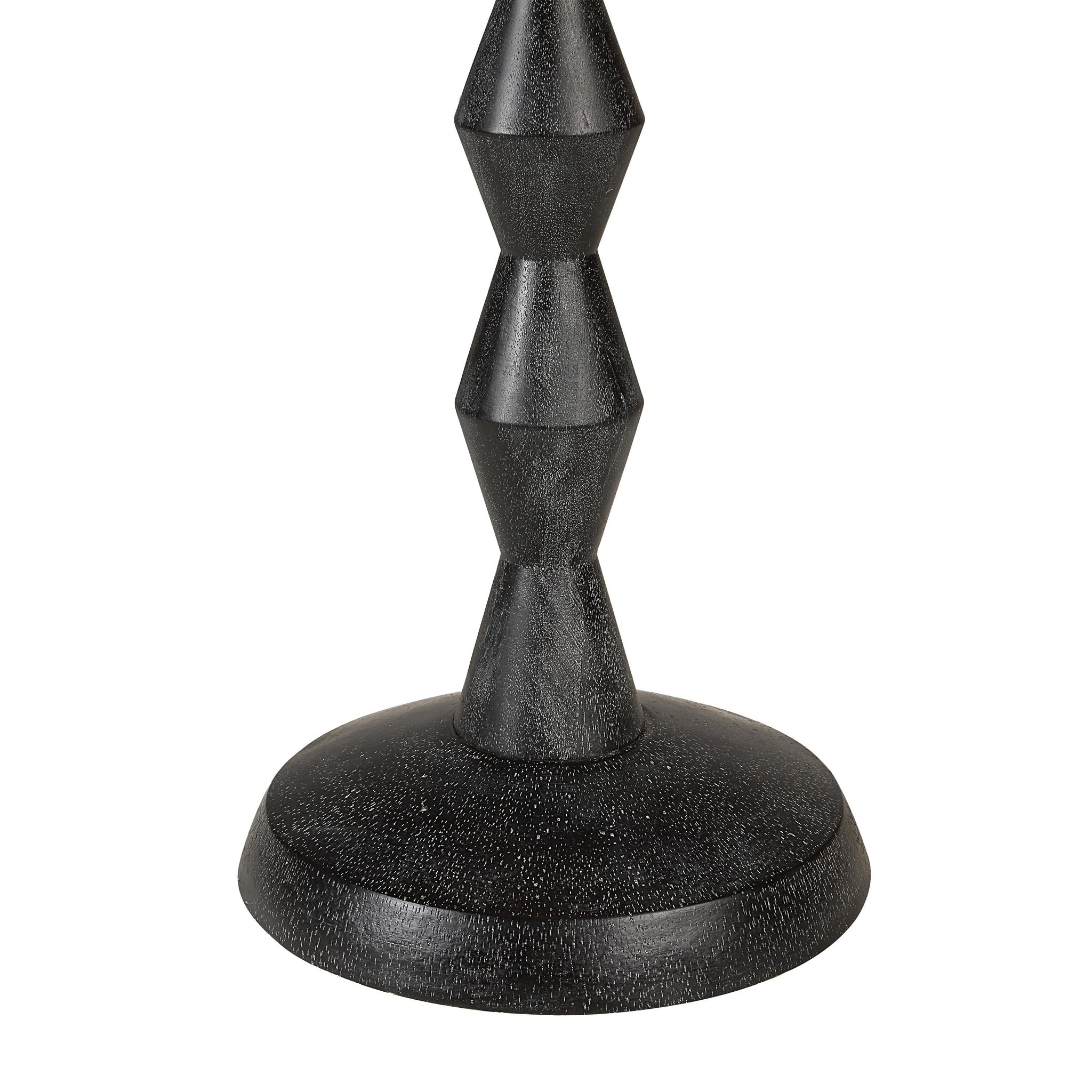Close-up of Phyllis floor lamp's textured black base with geometric shapes