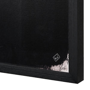 Close-up of Caramelo wall art showing black canvas with abstract shapes and logo detail.