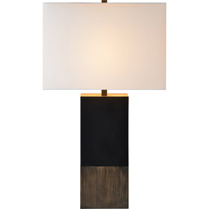 Broma Table Lamp illuminated, with a black and wood design and a white shade.