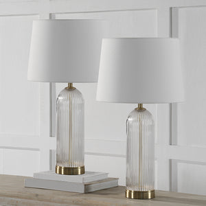 Ocala Table Lamp set of two on a wooden table with books and a white wall backdrop