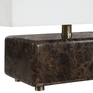 Close-up of Cabo table lamp showing dark marble base and brass details.