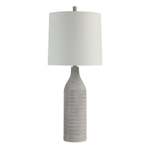 Baracoa table lamp with a textured gray ceramic base and white fabric shade.