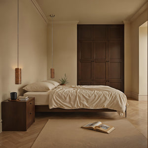 Bedroom interior featuring two Rue pendant lights by Renwil above a bed with neutral bedding