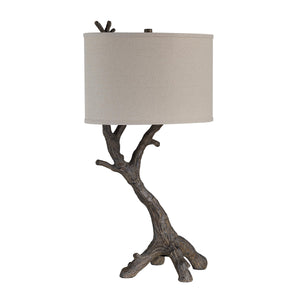 Loures table lamp featuring a textured branch base and a cylindrical beige shade.
