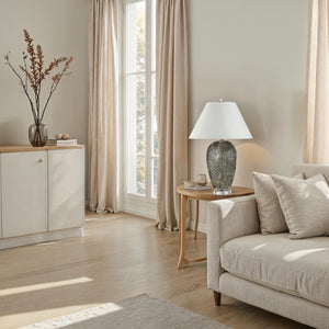 Poppi table lamp in a cozy living room setting with neutral decor and natural light