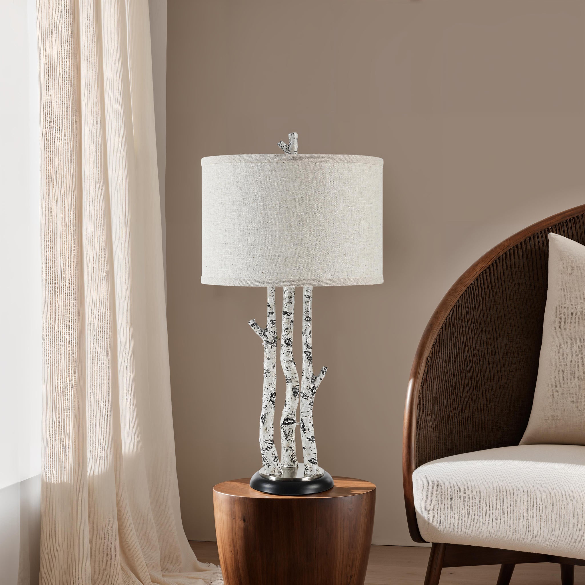 Naousa Table Lamp placed on a wooden side table next to a beige chair