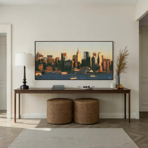 Panorama canvas art featuring a city skyline at sunset with warm tones.