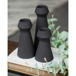 Granfeld Vase by Renwil in black, displayed with eucalyptus leaves on a coffee table.