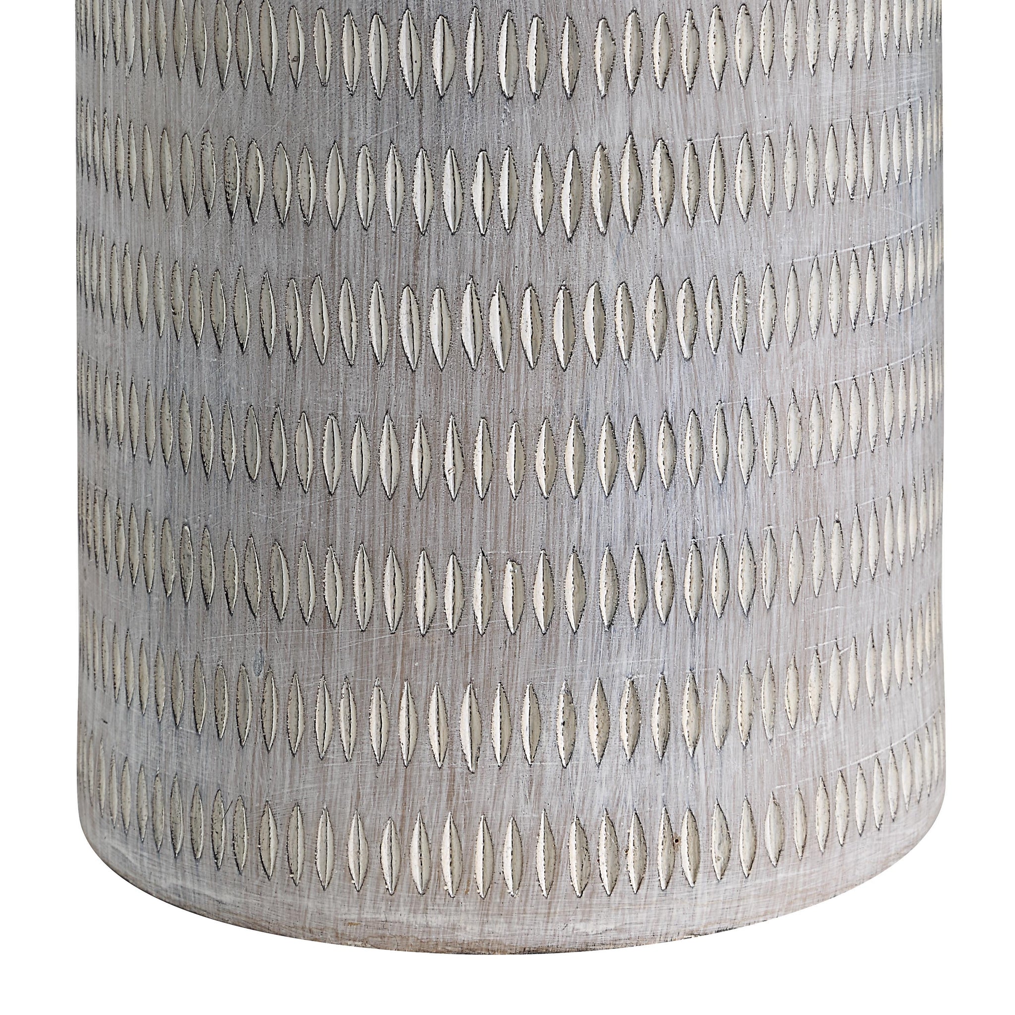 Close-up of Baracoa table lamp's gray ceramic base featuring an intricate pattern.
