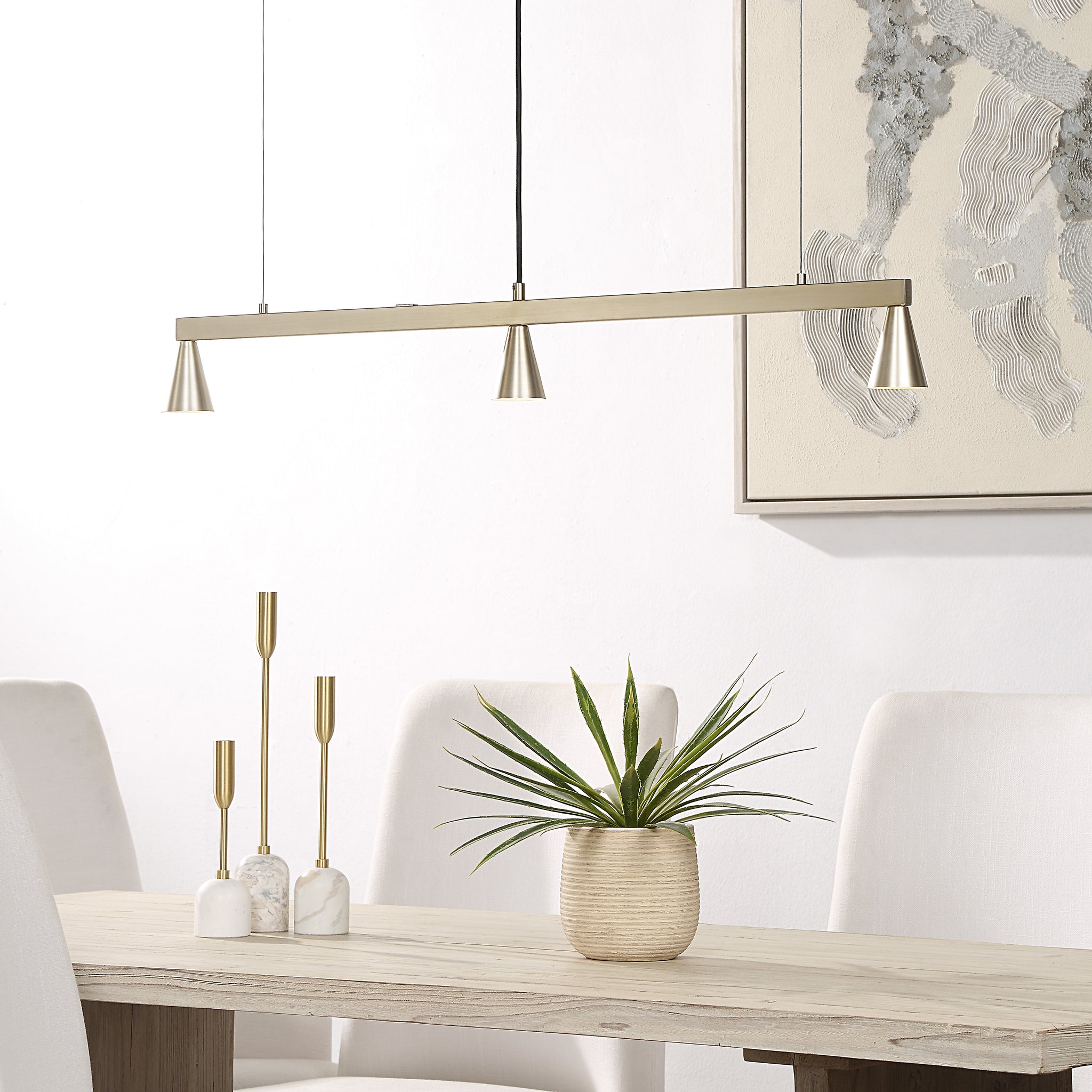 Linea Ceiling Fixture above a dining table with decorative elements and plant