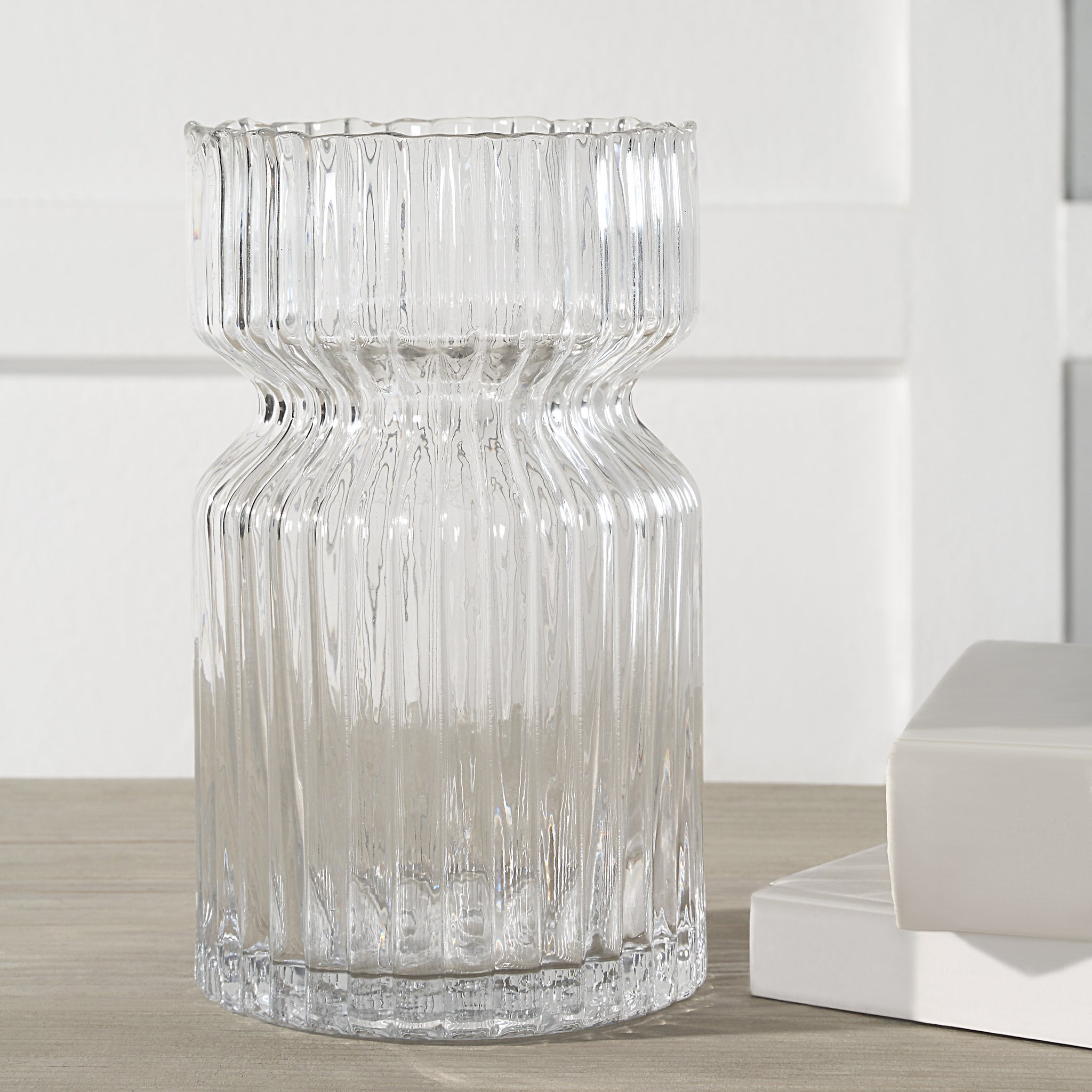 Gladys Glass Vase by Renwil, clear ribbed glass vase on wooden table, styled with books.