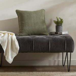 Lavigne Indoor Pillow styled on a tufted gray bench with a throw blanket and potted plant.
