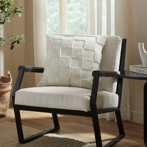 Terrah Indoor Pillow styled on a black armchair in a bright room