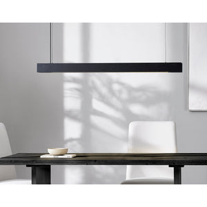 Taya Ceiling Fixture in black wood, linear design, hanging above a dark wooden table with white chairs.