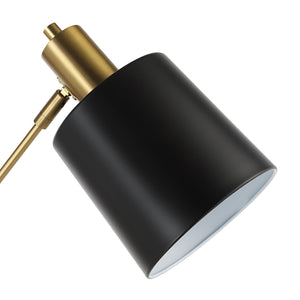 Close-up view of the black shade of the Meander floor lamp with gold hardware.