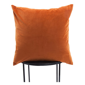 Prato Indoor Pillow in orange velvet, displayed on a black metal chair, highlighting its square shape.