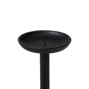 Close-up of Agra candle holder featuring a round dish on top, made of black metal.
