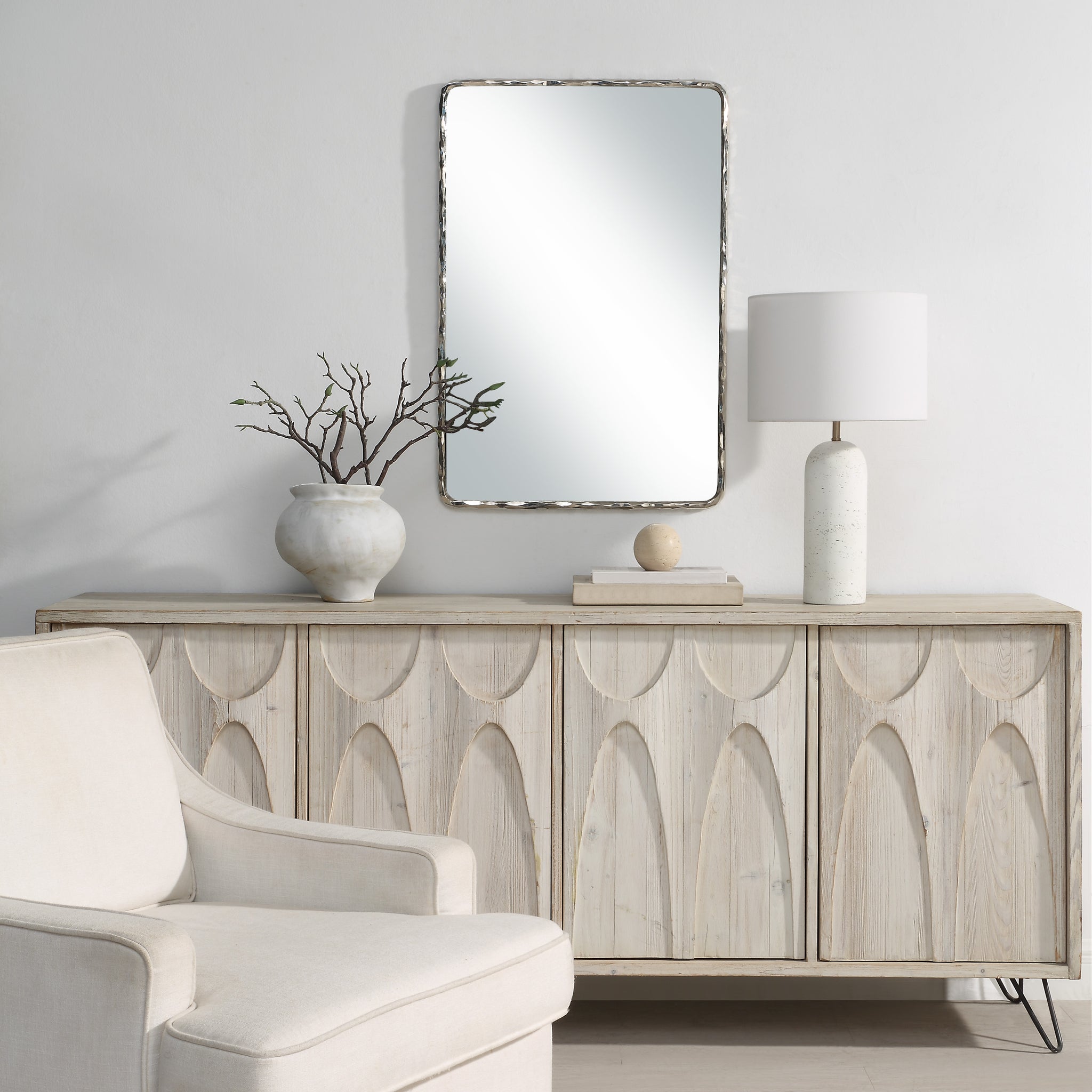 Pollonia mirror by Renwil displayed above a wooden console in a modern living room
