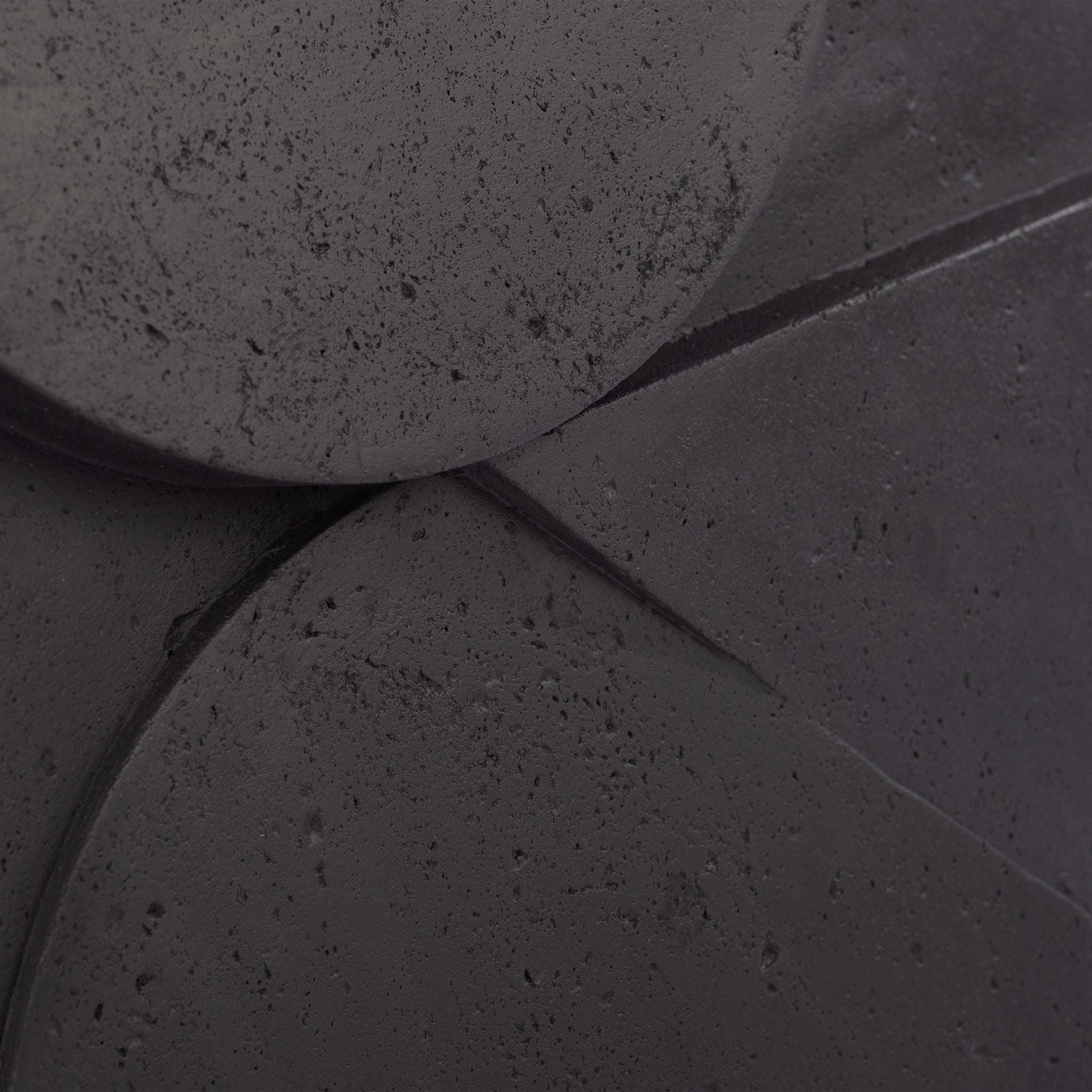 Close-up of Mura wall decor highlighting the textured surface and geometric details in dark gray.