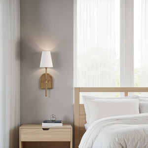 Montreux wall sconce installed beside a bed, illuminating a modern bedroom with soft light.