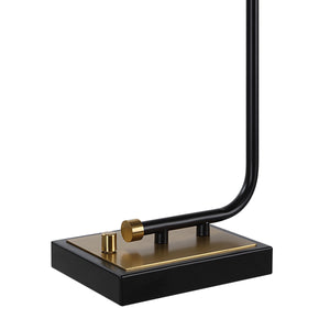 Perlato table lamp close-up of the black and gold base with a curved arm and switch.